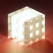 An abstract artwork with a glass cube and a glowing mesh inside it